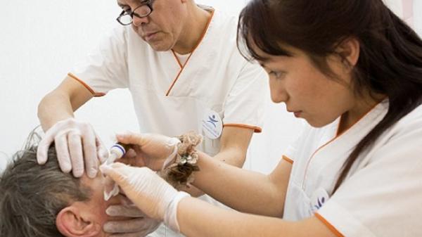 Doctor and nurse performing eye surgery